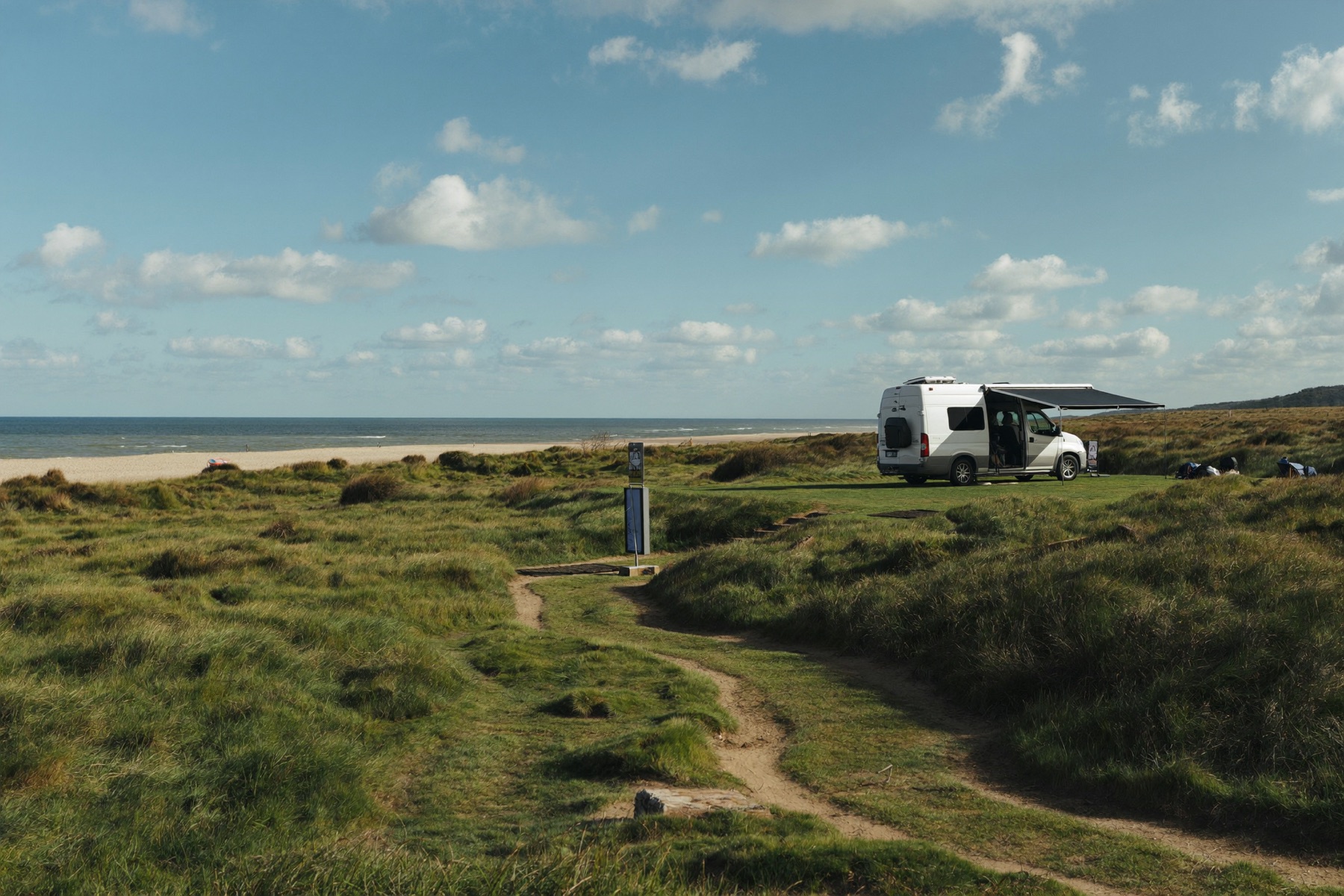 Powered site with campervan near the dunes